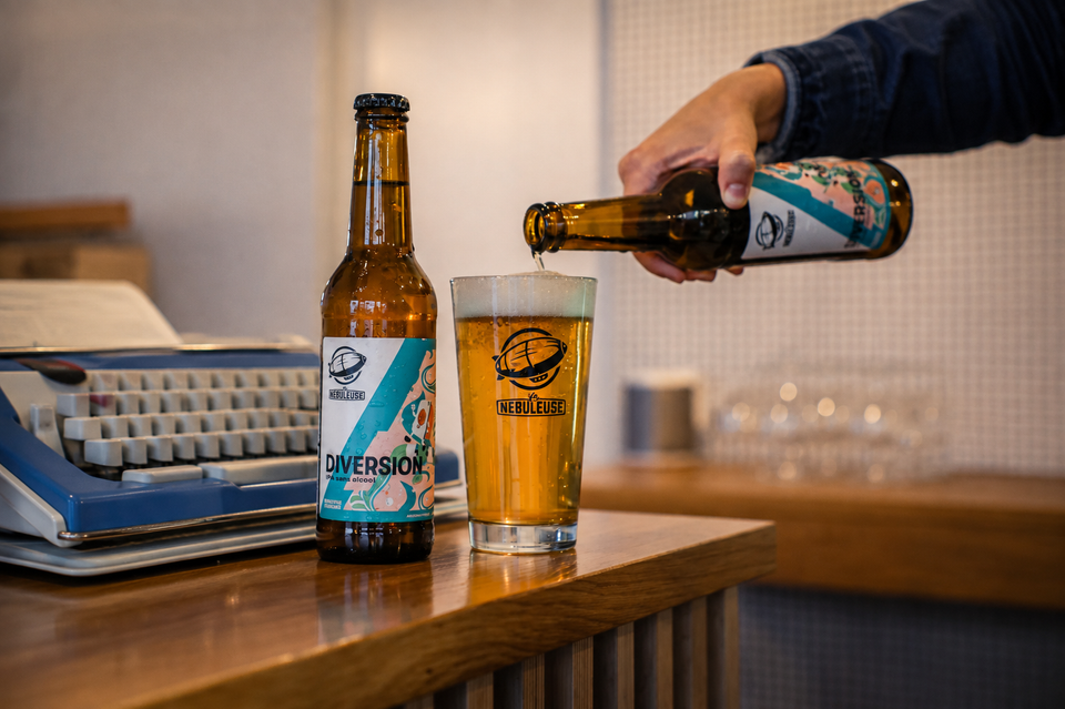 Une main en train de verser une bière Diversion.